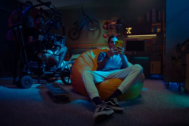 A young man sits on a beanbag using a smartphone on a film production set. Campaign case studies: a practical reference