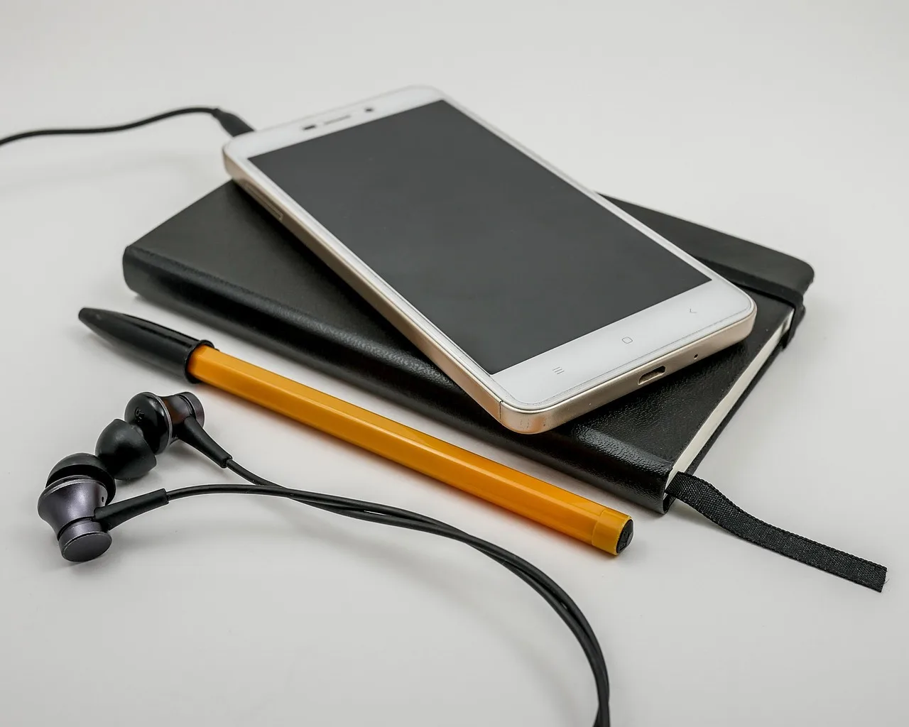 telephone, headphones, technology, smartphone, screen, communication, electronics, office, contact, sms, cell, business, white, notes, pen, black, orange, notebook, diary. Creator outreach strategy, decision by decision