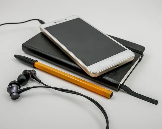 telephone, headphones, technology, smartphone, screen, communication, electronics, office, contact, sms, cell, business, white, notes, pen, black, orange, notebook, diary. Creator outreach strategy, decision by decision