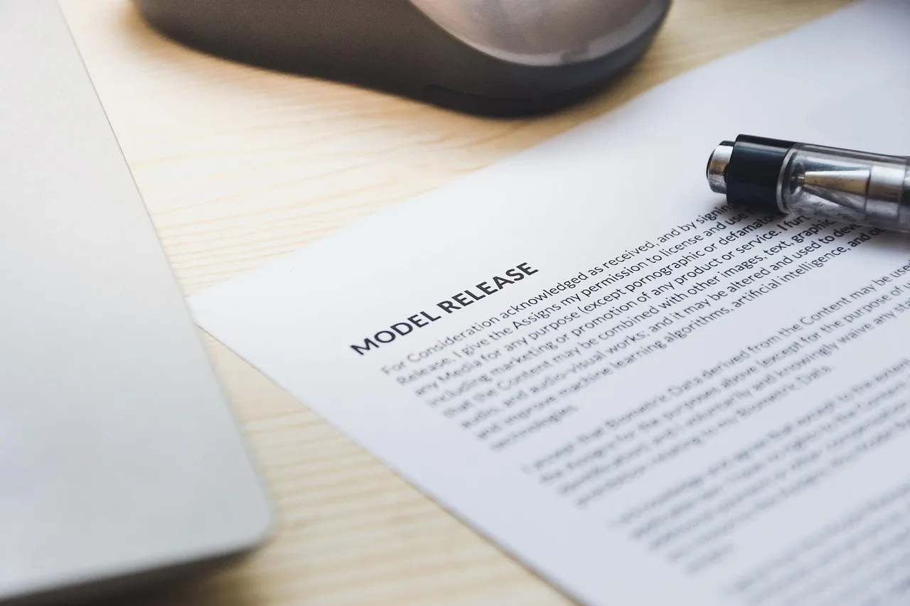 paper, model release, form, document, signing, pen, desk, agreement, business, contract, signature. Influencer sponsor partnerships: a US brand's first-campaign compliance map