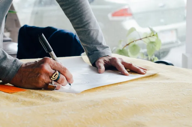 people, man, writing, paper, pen, plan, hand, ring, table, office. How to write a one page strategy and objectives plan